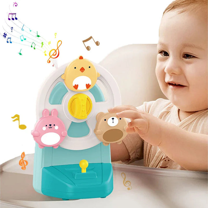 Baby reaching for the blue animal music box on a tray
