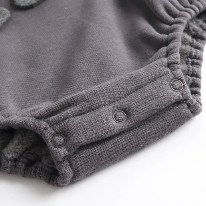 Crotch snaps and a gathered leg opening on the dark gray section of the baby romper