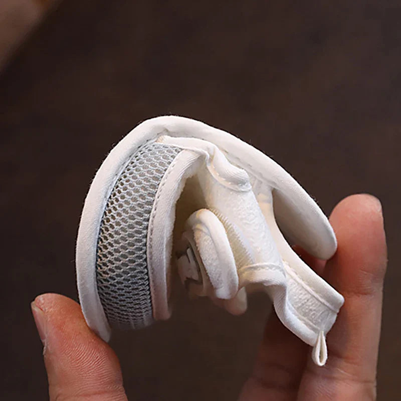 Baby sandal bent by hand to show its flexibility