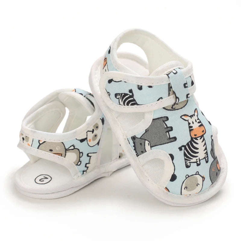 Light blue baby sandals arranged to show the animal-print front and open heel
