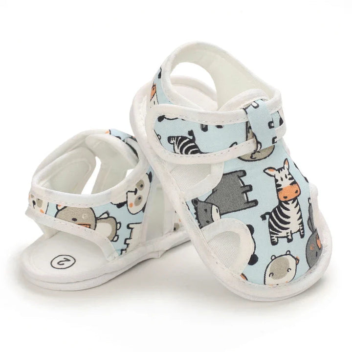 Light blue baby sandals arranged to show the animal-print front and open heel