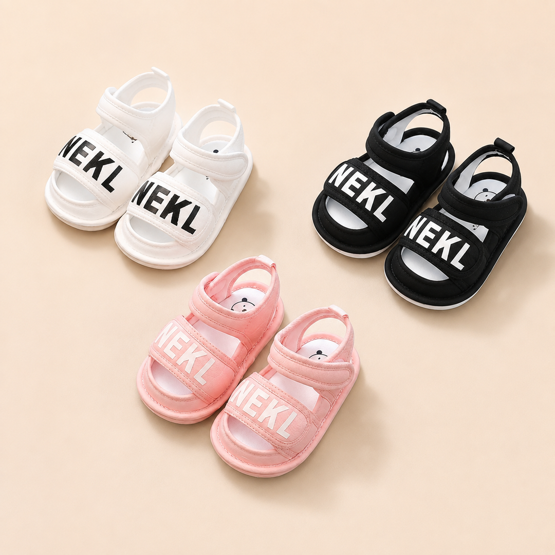 White, pink, and black baby sandals with wide front straps and adjustable ankle closures