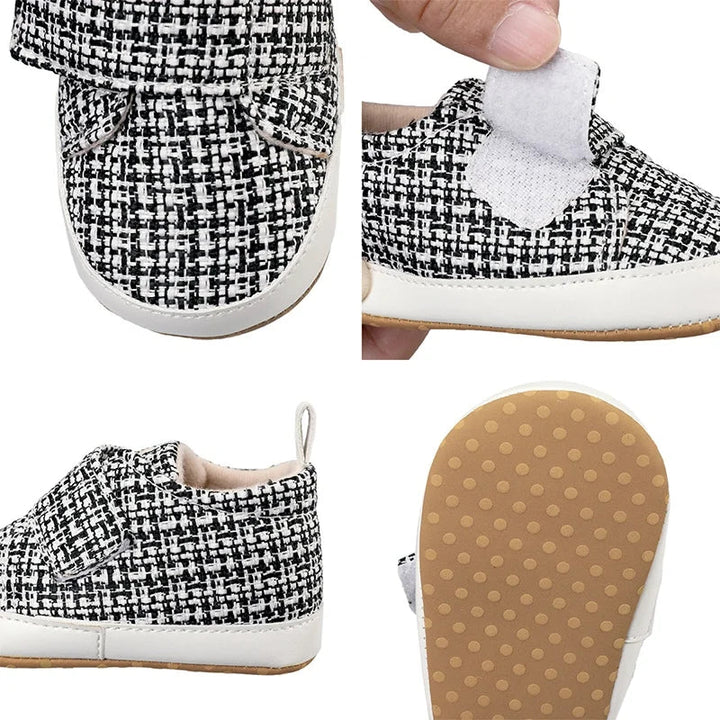 Close-up views of a black-and-white baby shoe, open strap, heel pull tab, and dotted outsole