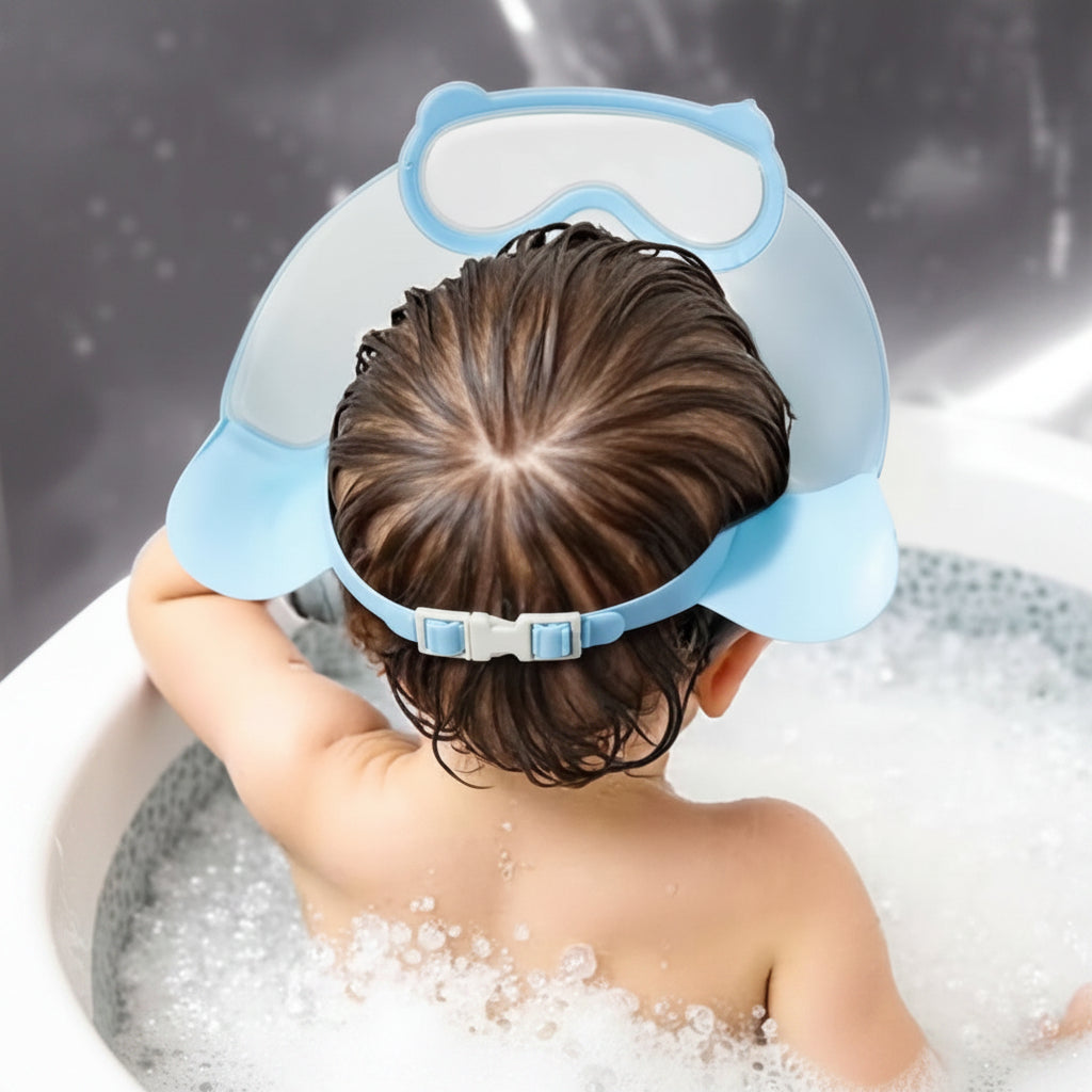 Rear view of a child wearing a blue shower cap with the adjustable strap fastened