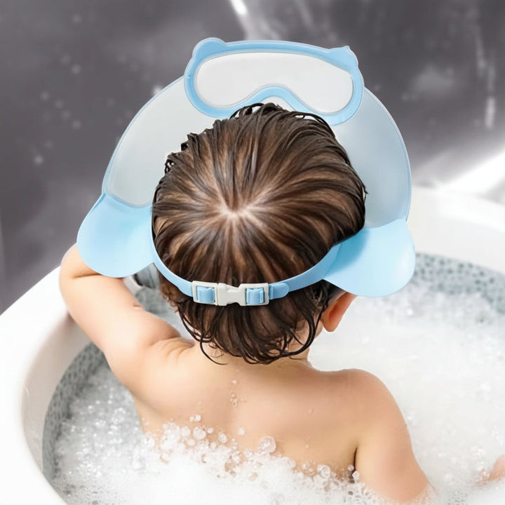 Rear view of a child wearing a blue shower cap with the adjustable strap fastened
