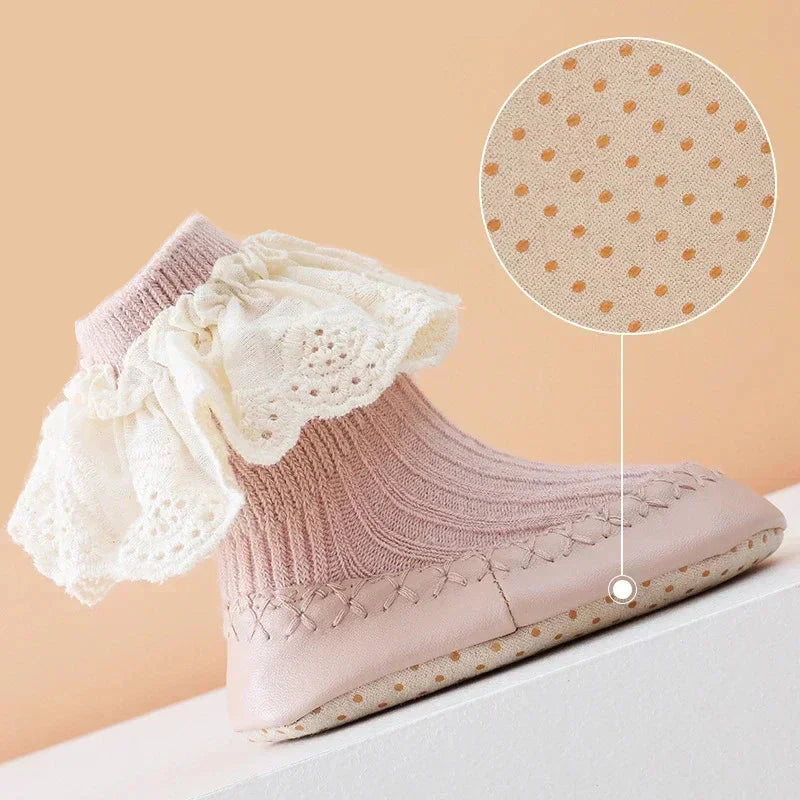Side view of a baby sock shoe with a magnified detail of the textured sole