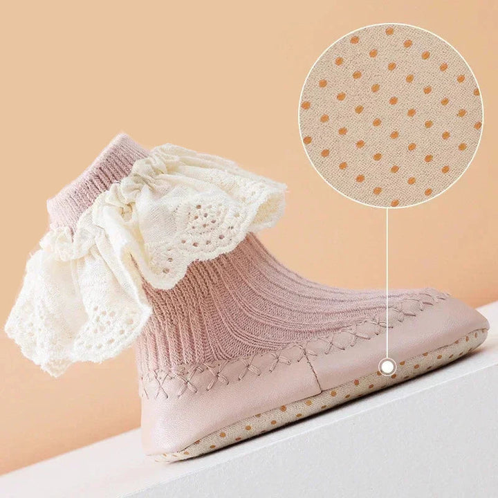 Side view of a baby sock shoe with a magnified detail of the textured sole