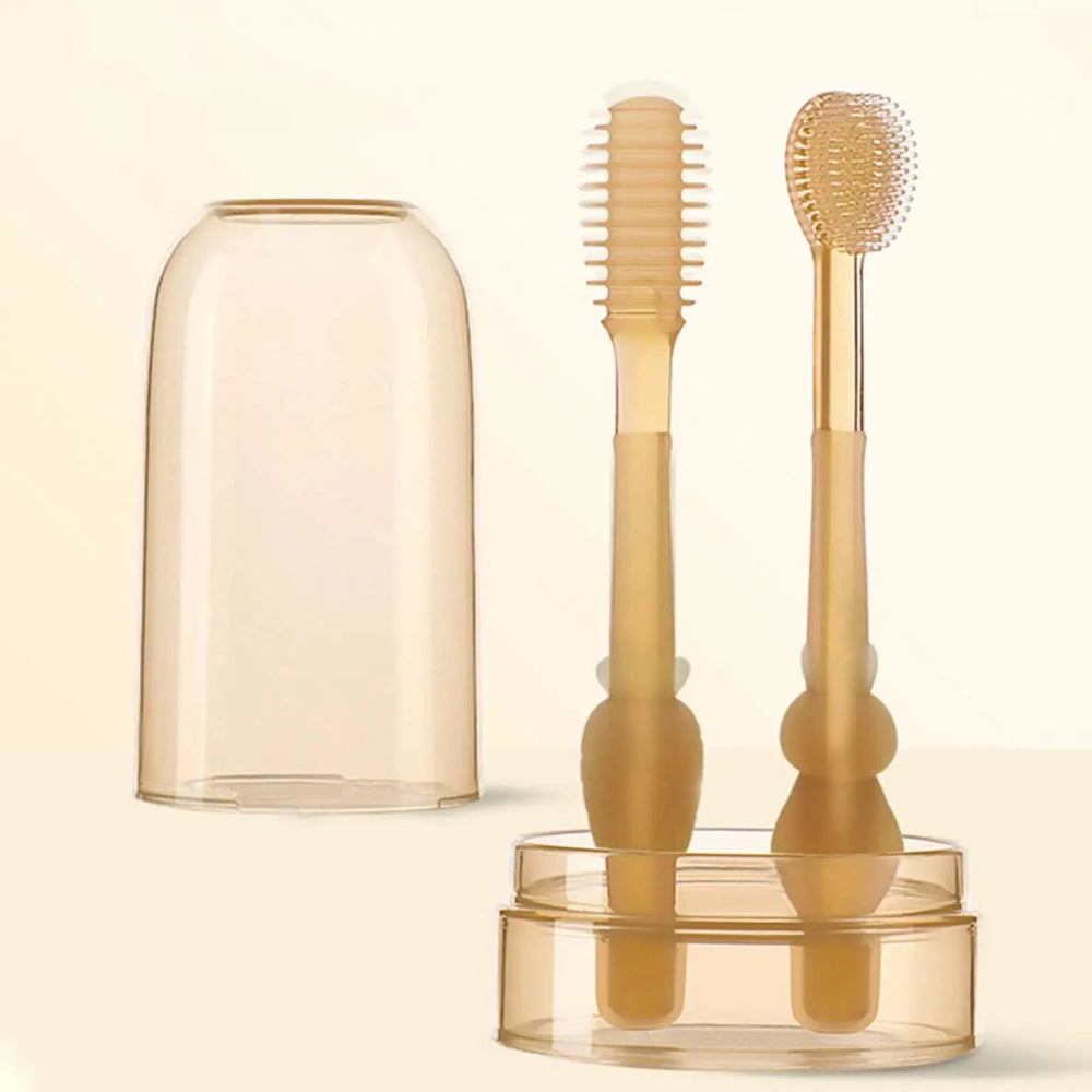 One-sided and rounded-head baby toothbrushes in a cup, with a translucent cover on a cream background