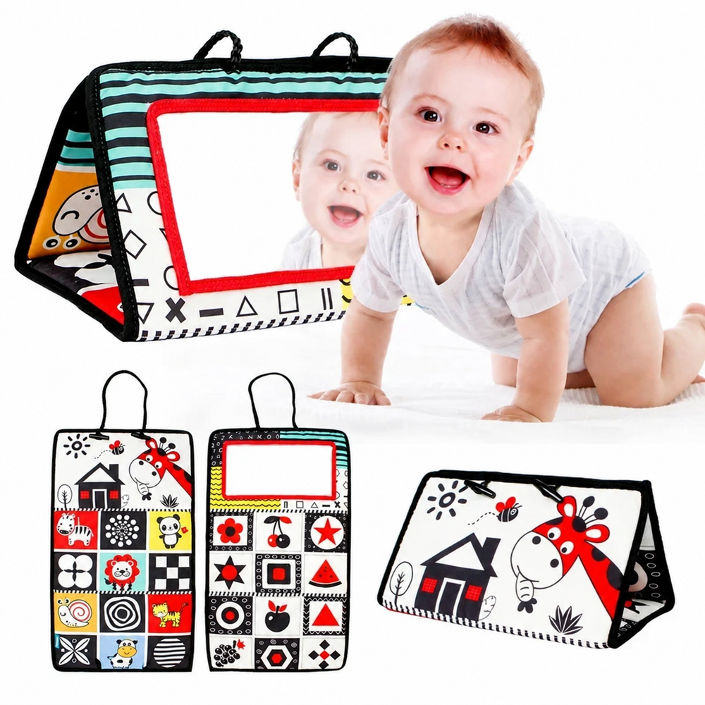 Baby beside a red-framed sensory mirror with views of its illustrated fabric panels