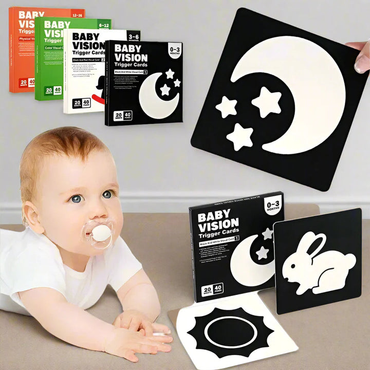 Baby looking toward black-and-white picture cards with moon, stars, rabbit, and sun designs