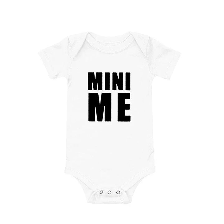 White baby bodysuit with black Mini Me lettering, an envelope neckline, and bottom snaps