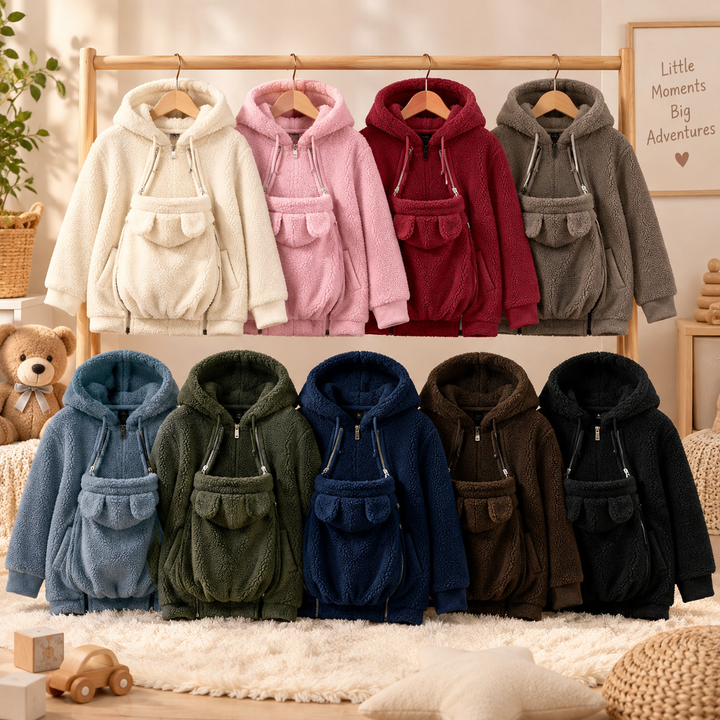 Hooded babywearing jackets in nine colors displayed on a wooden rack