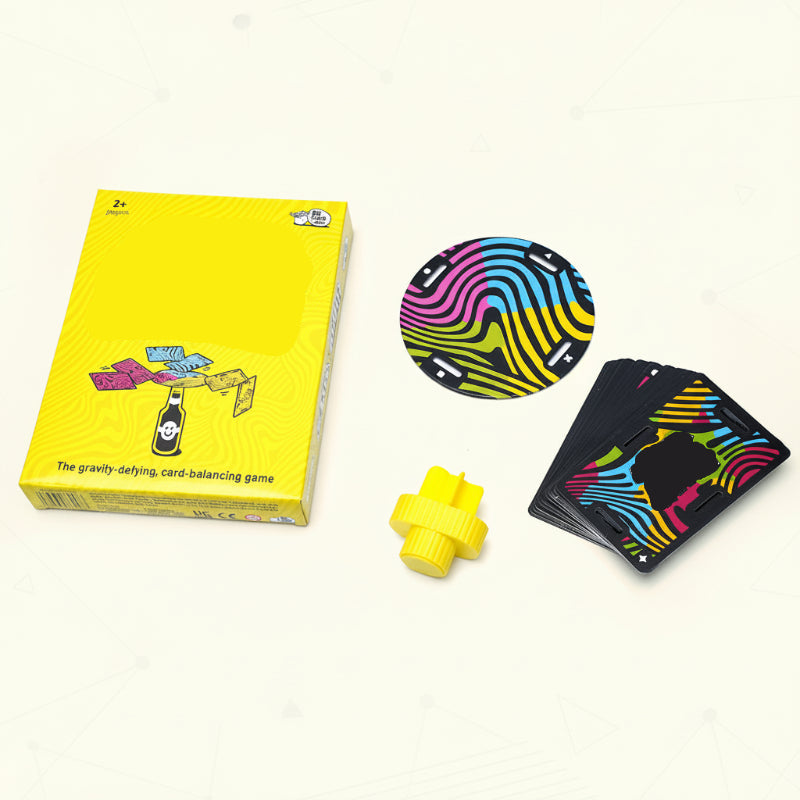 Balance game set with a yellow box, slotted cards, colorful disc, and yellow bottle stopper.