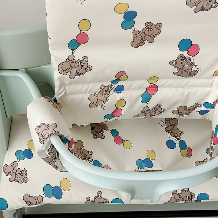 Close-up of the balloon-bear print on the padded high chair seat and backrest