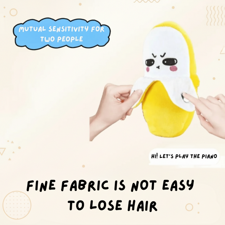 Two hands touching the banana plush piano&