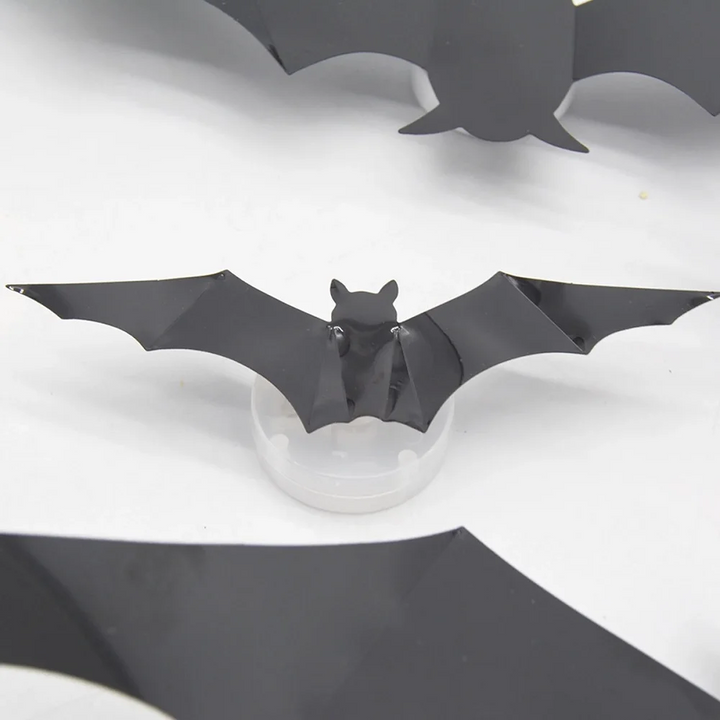 Black bat decoration positioned over a round LED light unit