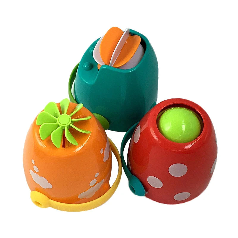 Teal, orange, and red bath buckets turned over to show their colorful bases.