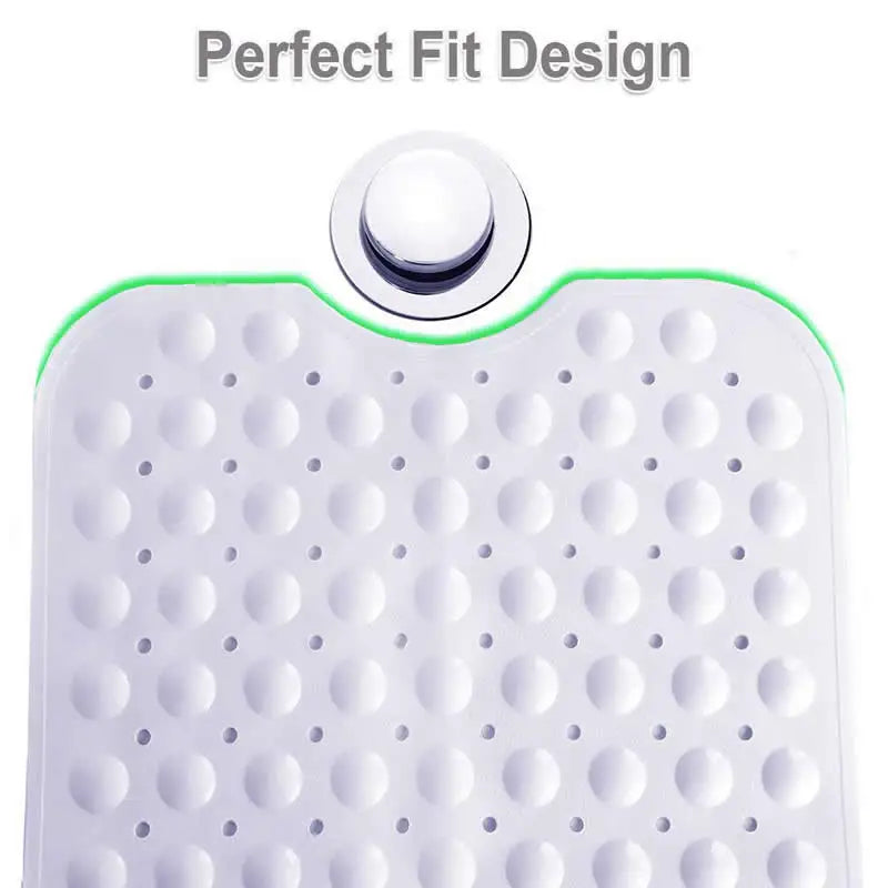 Bath mat end with a curved cutout beside a tub drain and round surface bumps