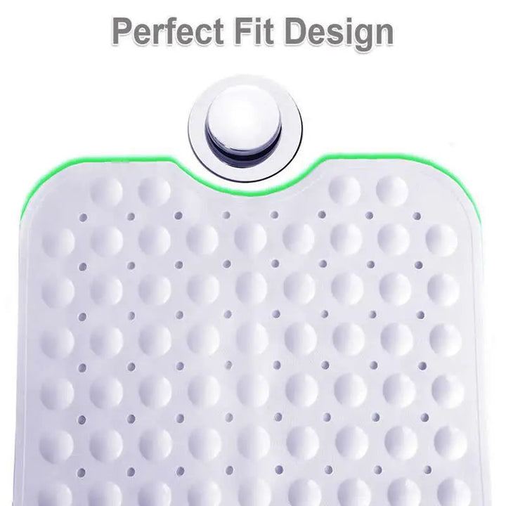 Bath mat end with a curved cutout beside a tub drain and round surface bumps