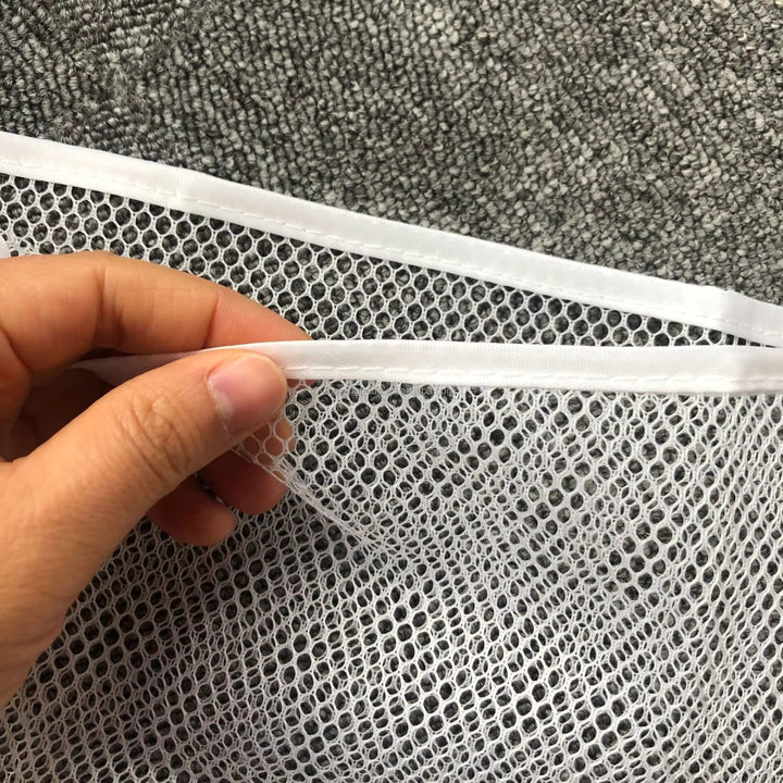 Close-up of the white mesh and edging on a bath storage net