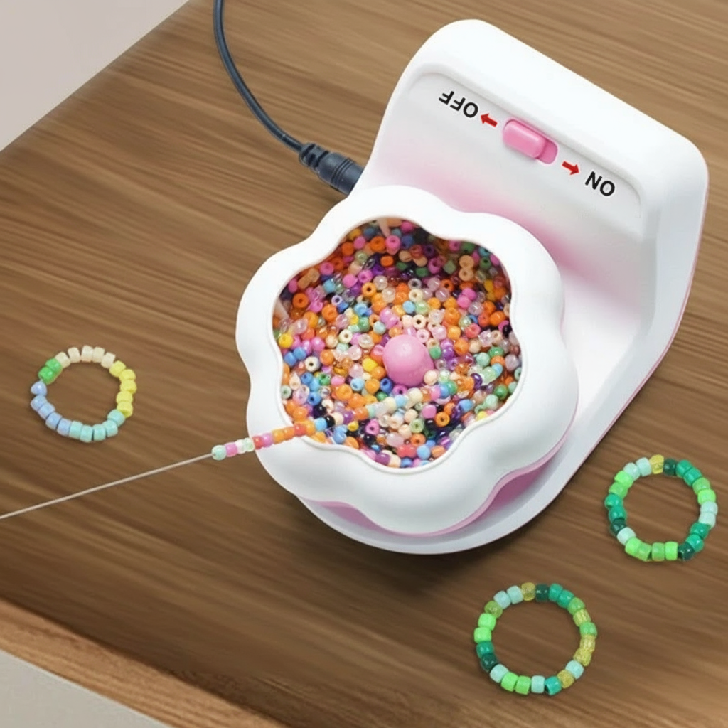 Pink-and-white electric beading machine with a flower-shaped bowl, colorful beads, and finished bracelets.