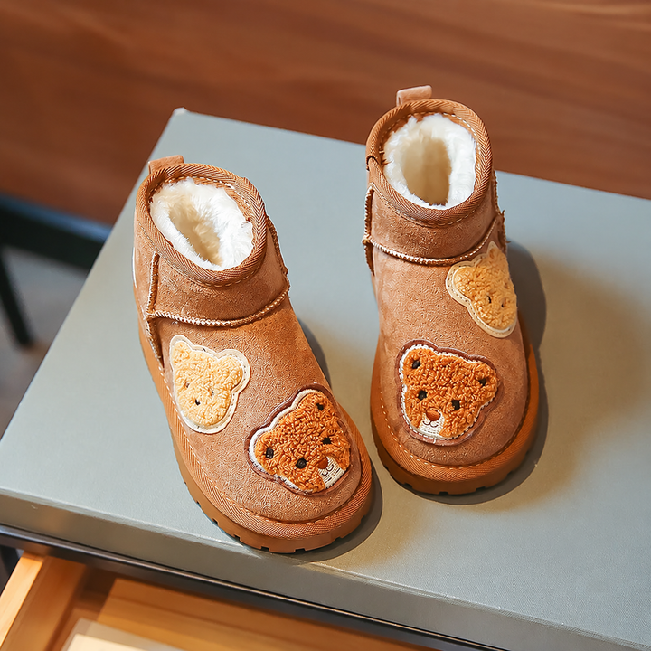 Brown bear-detail ankle boots viewed from above, showing cream plush lining