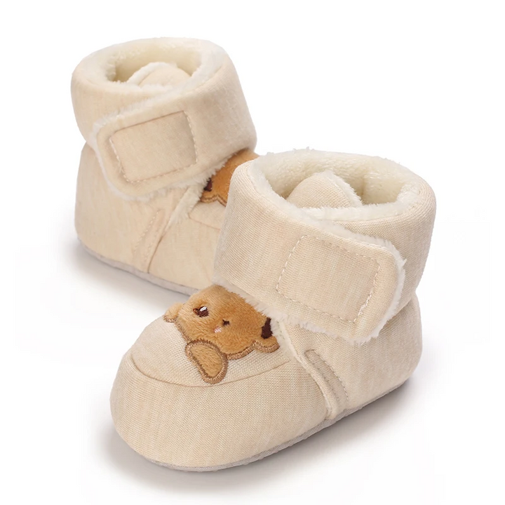 Pair of beige bear baby boots showing their wide hook-and-loop ankle straps