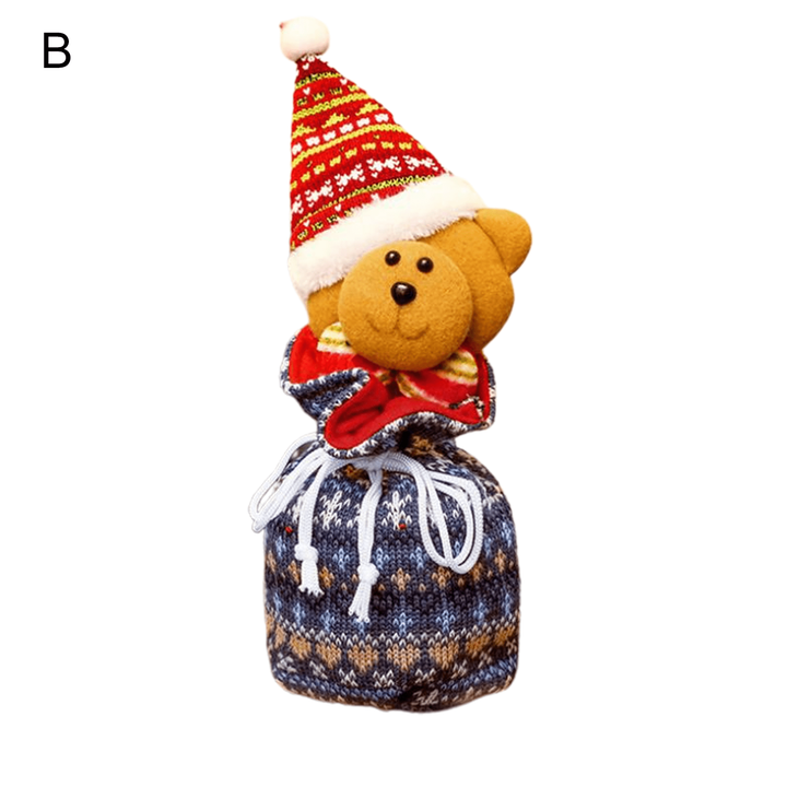 Bear gift bag with blue patterned fabric, white drawstrings, and a tall red Christmas hat.