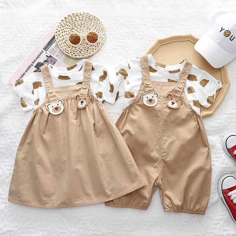 Beige dress and pants outfit sets with bear-print T-shirts laid flat side by side