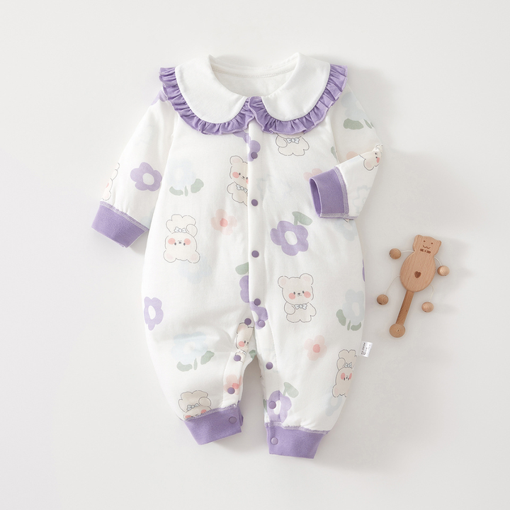 Bear-and-flower baby pajamas with purple cuffs and a ruffled collar