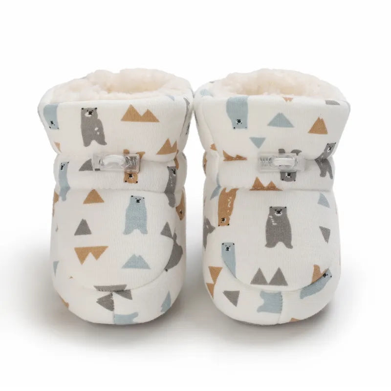 Front view of bear-print baby slippers with lined cuffs and ankle fastenings