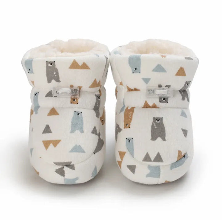 Front view of bear-print baby slippers with lined cuffs and ankle fastenings