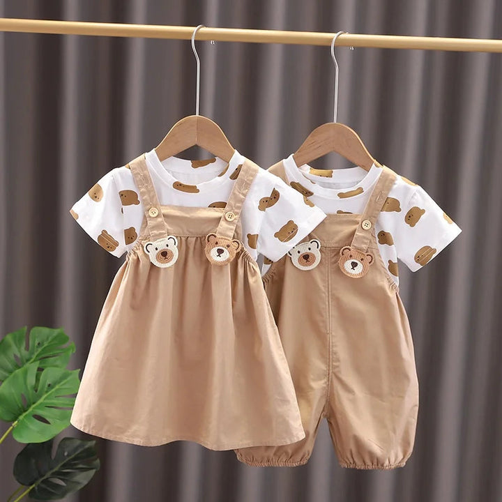 Beige bear-detail dress and overall-style pants sets with white bear-print T-shirts hanging side by side