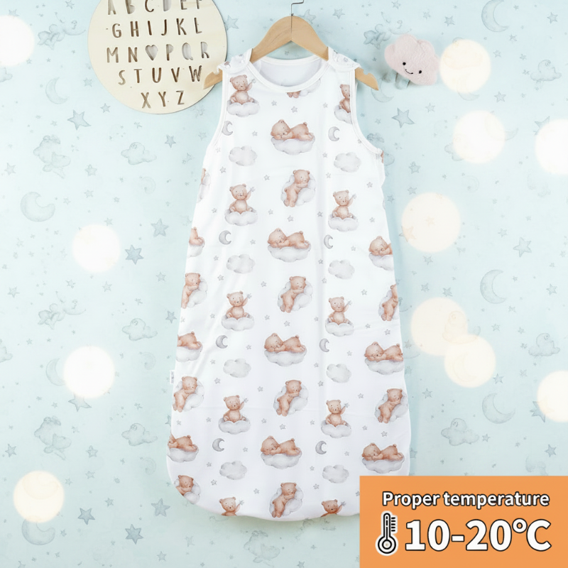 White bear-print baby sleep sack hanging against a pale blue background