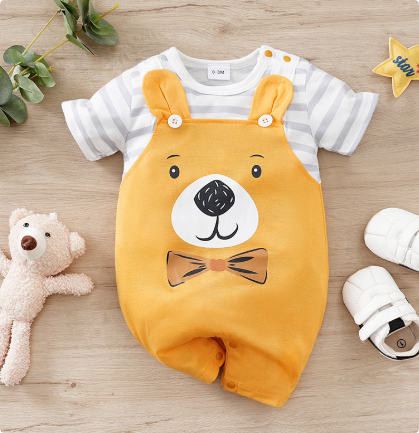 Yellow bear baby romper with striped sleeves, laid flat beside a teddy bear