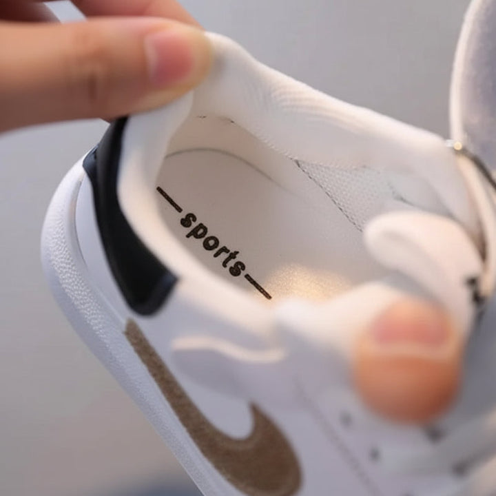 View inside a white bear sneaker showing the lining and footbed.