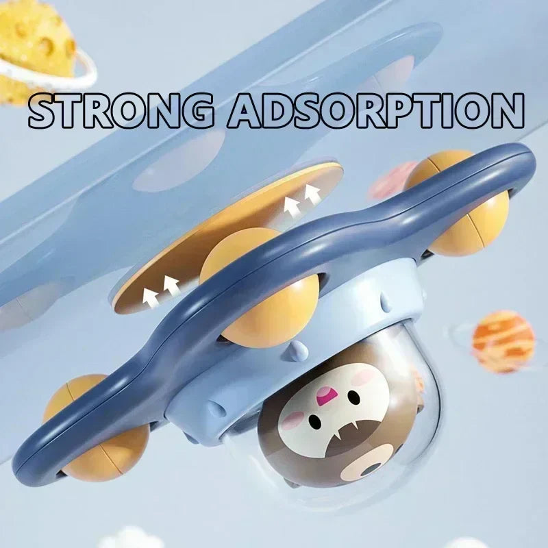 Side view of the blue bear spinner attached to a smooth surface by its yellow suction cup