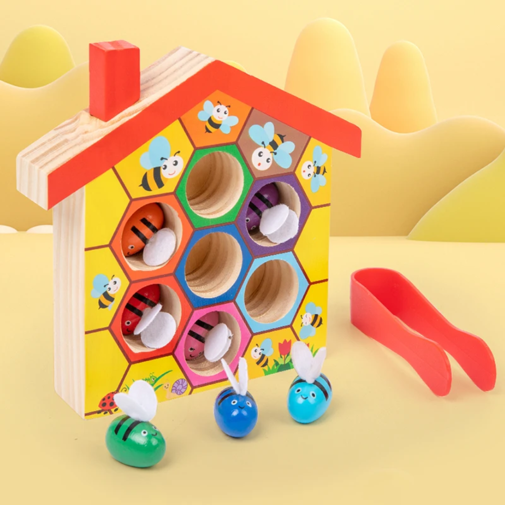 Wooden beehive sorting board with bees in color-ringed openings and red tweezers