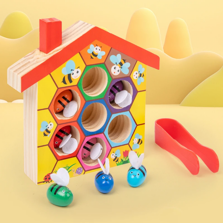 Wooden beehive sorting board with bees in color-ringed openings and red tweezers