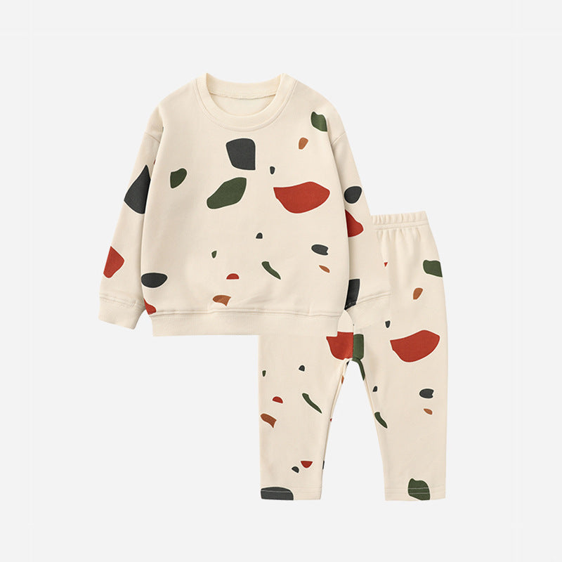Beige long-sleeve sweater and matching pants with a multicolored abstract print.