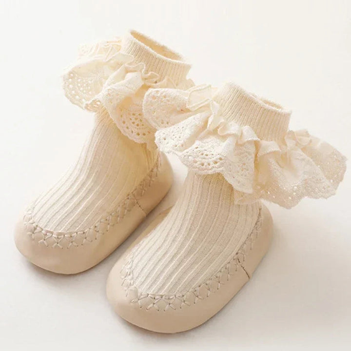 Beige baby sock shoes with cream ruffled lace cuffs and matching soles