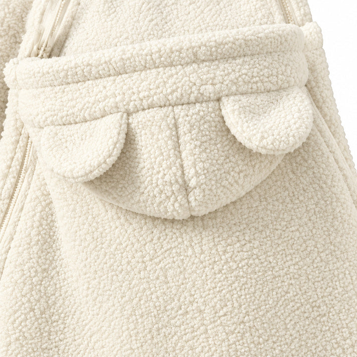 Beige front carrying section with a folded top edge and rounded ear details