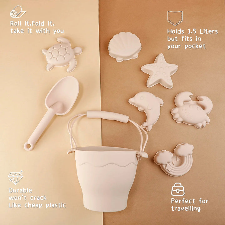 Beige silicone bucket and shovel with six sea-themed molds arranged on a brown surface.