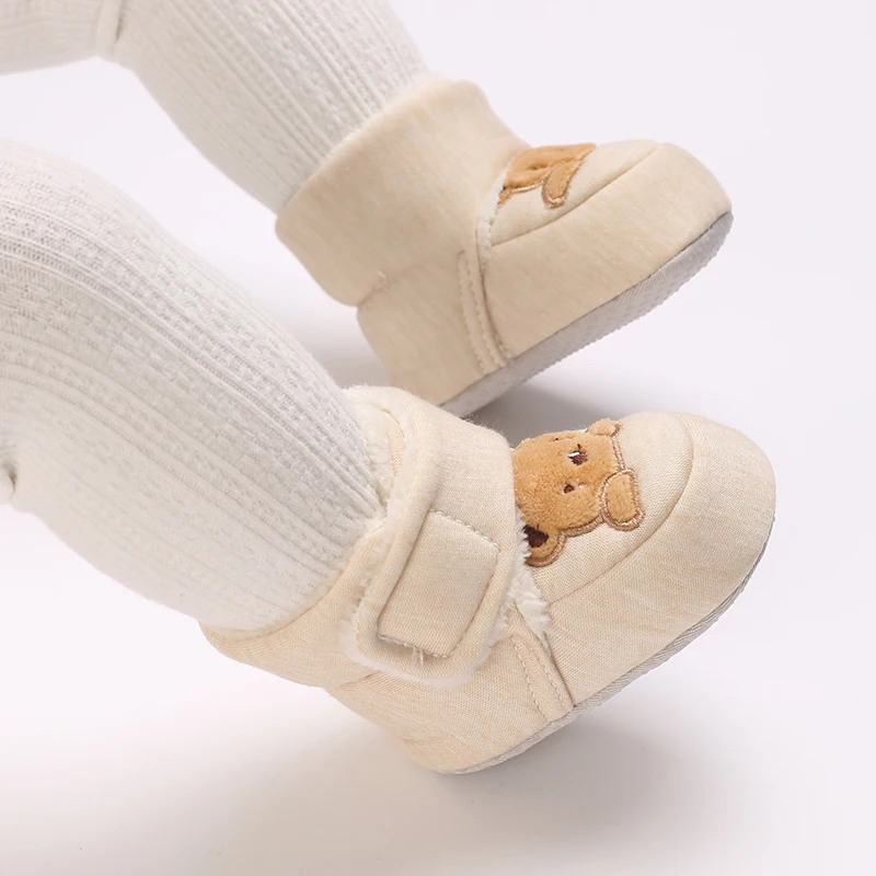 Beige bear baby shoes on a baby&