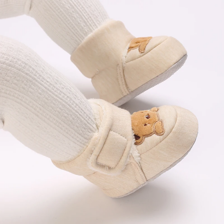 Beige bear baby shoes on a baby&