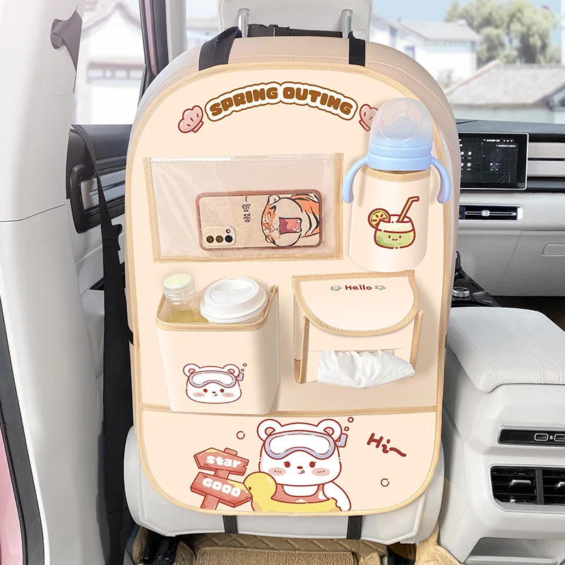 Beige bear car organizer mounted behind a front seat with multiple filled pockets