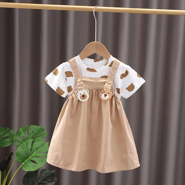 Beige bear-detail overall dress with a white short-sleeve bear-print T-shirt