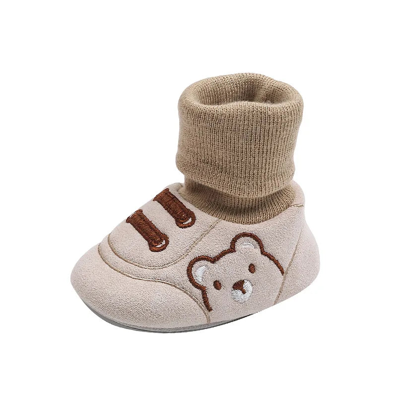 Single beige sock shoe showing its ribbed cuff and bear design