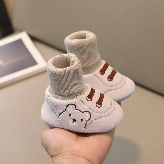 Beige baby sock shoes with bear faces and brown stitched details