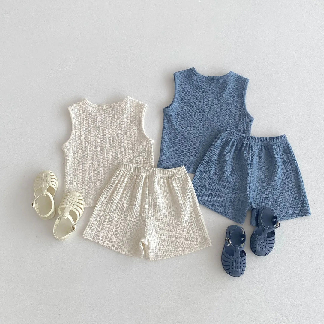 Beige and blue matching sets with sleeveless tops and gathered-waist shorts.